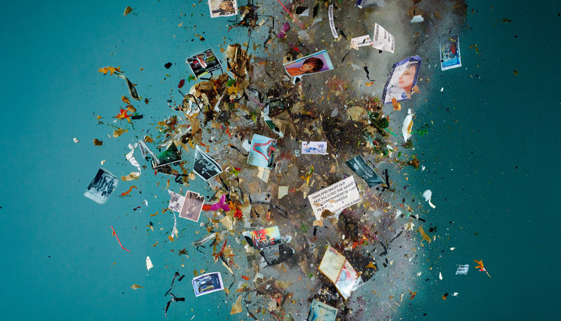 Image of detritus and confetti in explosion, blue background.