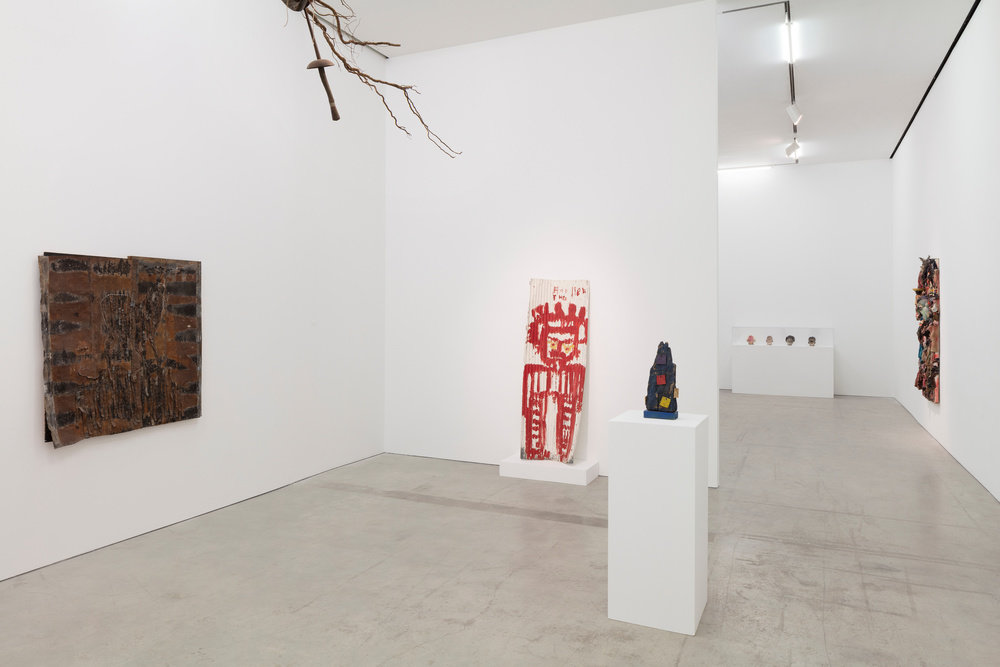 An installation view of multiple sculptures and paintings.