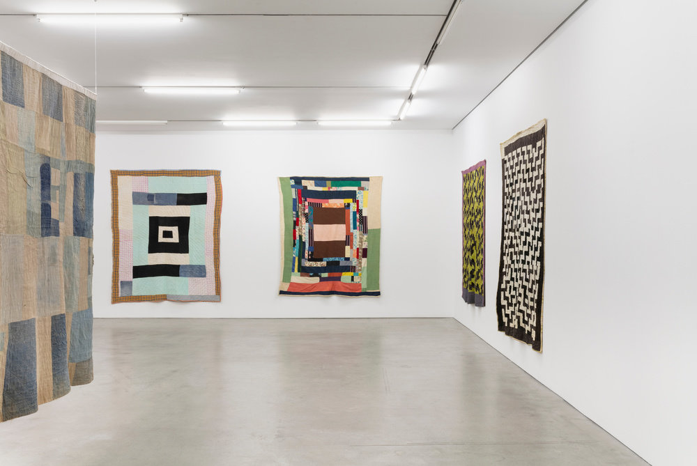 And installation view of various quilts.