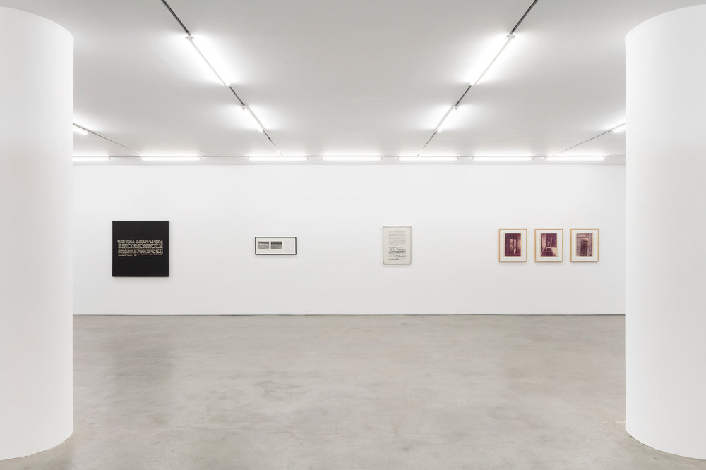An installation view of four works hung on a gallery wall. 