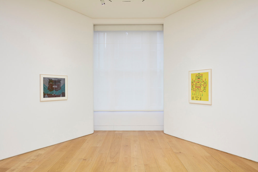An installation view of two Karl Wirsum framed works on paper on two opposite walls. 