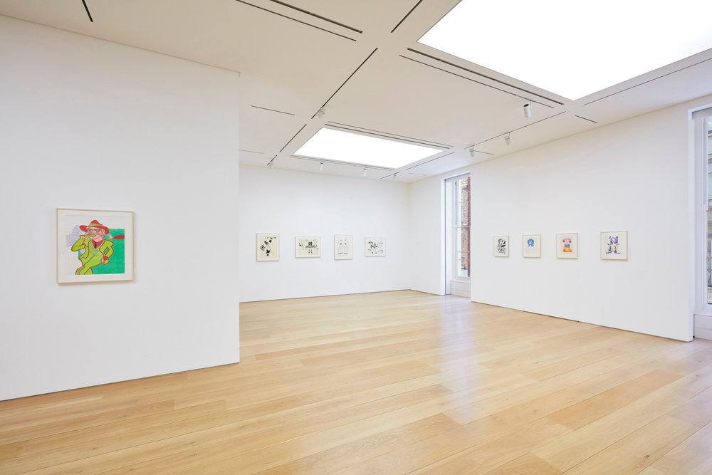 A partial view of nine Karl Wirsum framed works on paper hanging in the gallery. 